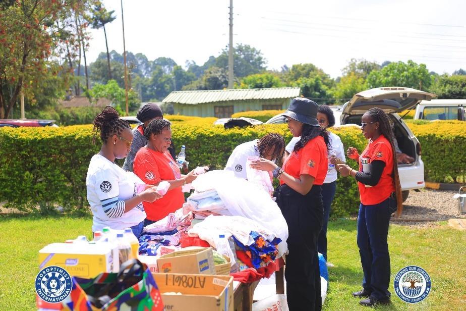 Greening Our Horizons team members organising donated clothing and toys